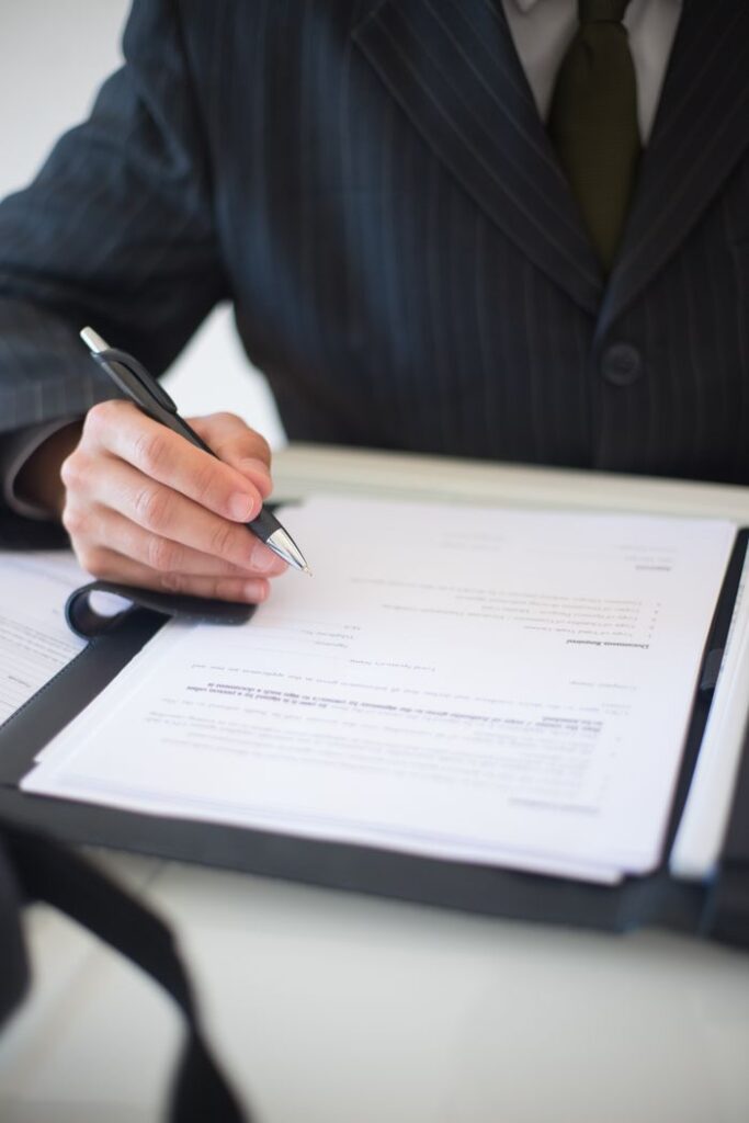 a person s hand holding a black and silver pen 8815843 a person s hand holding a black and silver pen 8815843